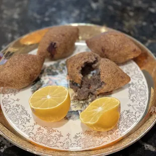 a plate of food with lemons