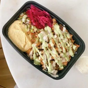 a salad in a plastic container on a table