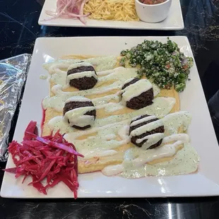 Hummus plate with falafel and tabooli. A piece of pita bread came on the side.