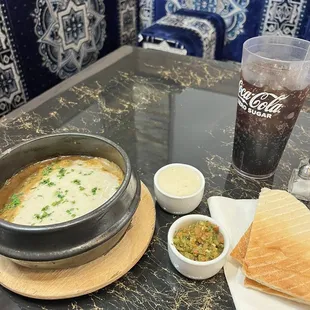 Selta! Yemeni stew with shredded beef, simmering in dark onion gravy, with chopped potatoes, topped with whipped fenugreek &amp; sahowka!