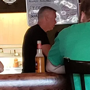 two men sitting at the bar