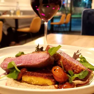 a plate of food and a glass of wine