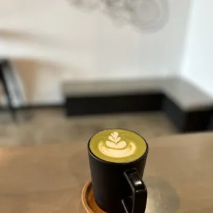 a cappuccino in a black cup