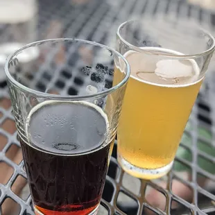 two glasses of beer on a table