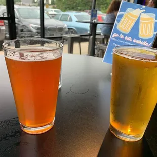 two glasses of beer on a table