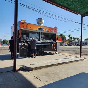 a man standing in front of a food truck