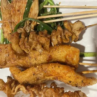 Chicken skin, enoki mushroom, rice cakes, and chives.