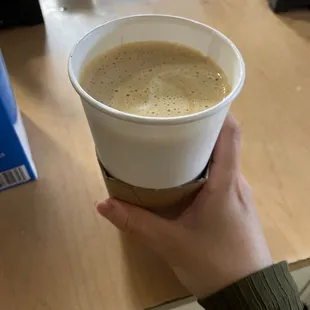 a person holding a cup of coffee