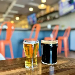 two glasses of beer on a table