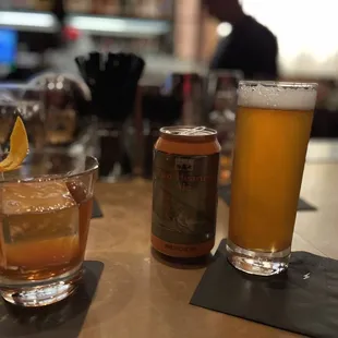 two glasses of beer and a can of beer