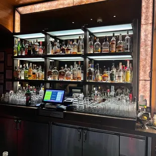 a bar with a lot of liquor bottles