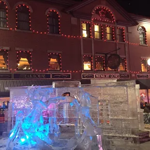 Ice sculptures illuminated at night during the Cripple Creek ice festival.