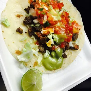 Carne asada, cabbage, pico, guac and red salsa Taco on flour tortilla. Sonora style.