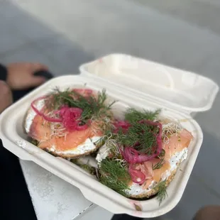 a person holding a container of food