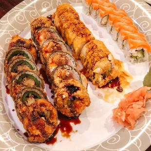 a plate of sushi and rolls