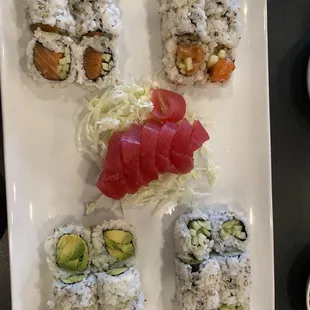 Tuna sashimi, cucumber roll, avocado roll, salmon roll and spicy salmon roll.
