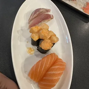 Roll in the back was a Tuna roll with spicy tuna inside and raw on the outside   Nigiri: albacore, spicy scallops, salmon