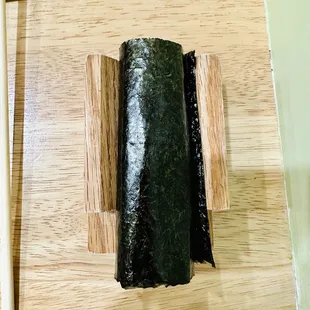 a sushi roll on a chopping board