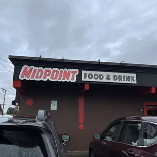 two cars parked in front of the restaurant