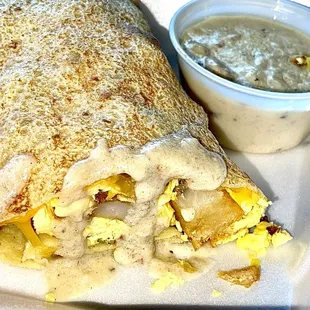 CREPITO CREPE, BACON, CHEDDAR CHEESE, SCRAMBLED EGGS, &amp; COUNTRY POTATOES TOPPED WITH SAUSAGE GRAVY