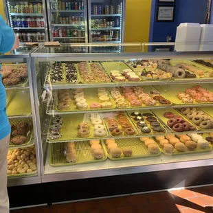 a display case with a variety of donuts