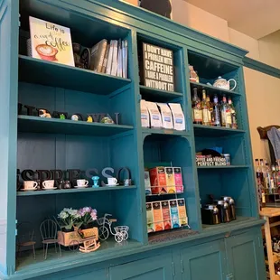 a shelf of coffee and tea