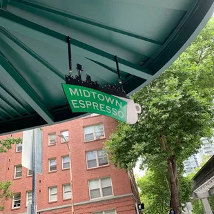 a street sign for midtown espresso