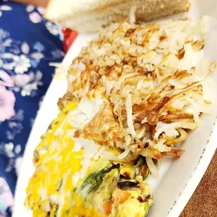 an omelet, toast, and hash browns on a plate