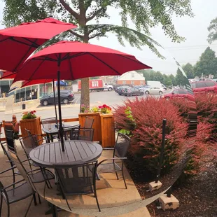 a patio with tables and umbrellas