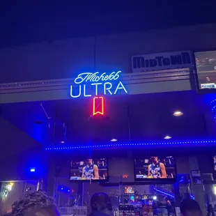 a neon sign above the entrance