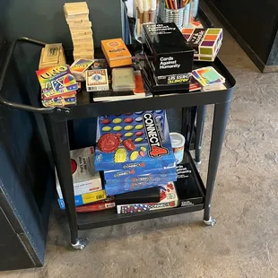 a black cart filled with books and games