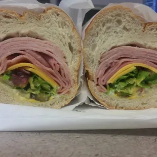 12 inch Club on French Bread. Ham, Turkey, American cheese, lettuce, tomato, onion, pickles, mustard, mayo, oil, vinegar: $7.29.