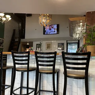 a bar with four stools