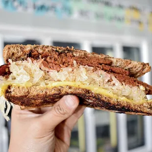 The Reuben Sandwich! Unreal Deli Corned Beef, sauerkraut, thousand island dressing, and cheese on rye.