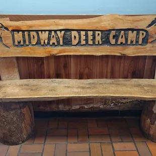 a wooden bench with a sign on it