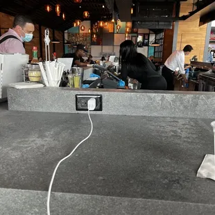 a man in a face mask behind the counter