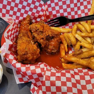 3 Chicken Tenders in Buffalo sauce with fries.