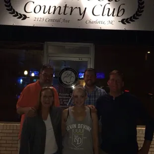 a group of people standing in front of a building