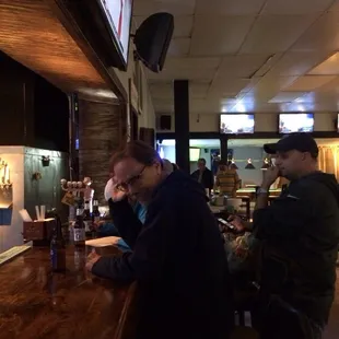 two men sitting at a bar