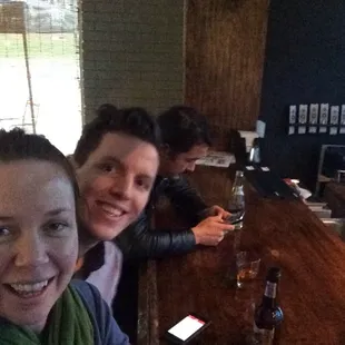 three people sitting at a bar