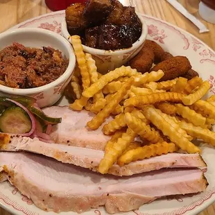 Smoked brisket pieces, hush puppies, crispy fries, and smoked turkey.