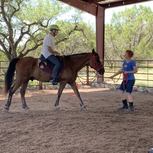 My boyfriend being coached and led through his horsemanship lesson with Genevieve (on Sumo).