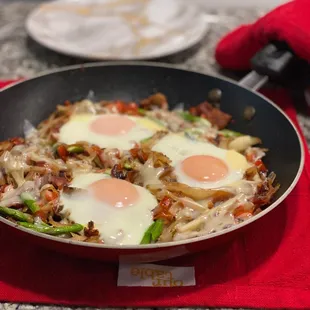 a frying pan with fried eggs