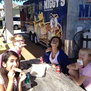 a group of girls eating food