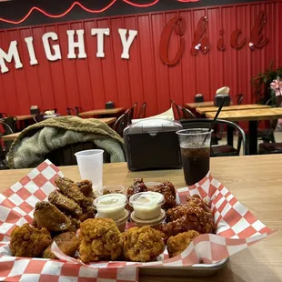 a tray of fried chicken and a drink