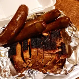 a plate of meat and sausages