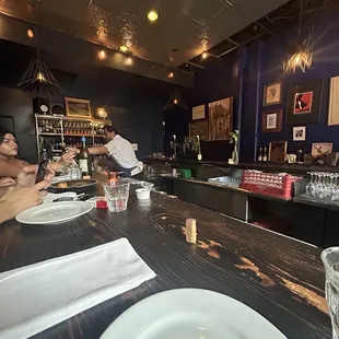 two people sitting at a bar