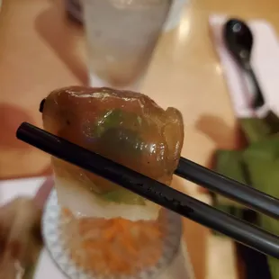 chopsticks holding a piece of food