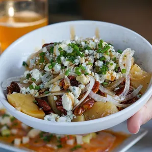 a person holding a bowl of food