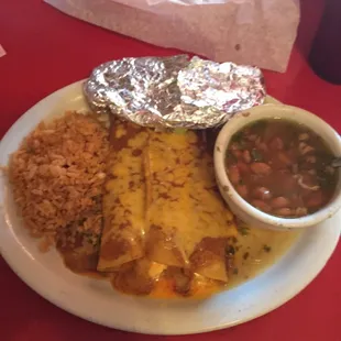 Yummy cheese enchiladas with a side of rice and charro beans..